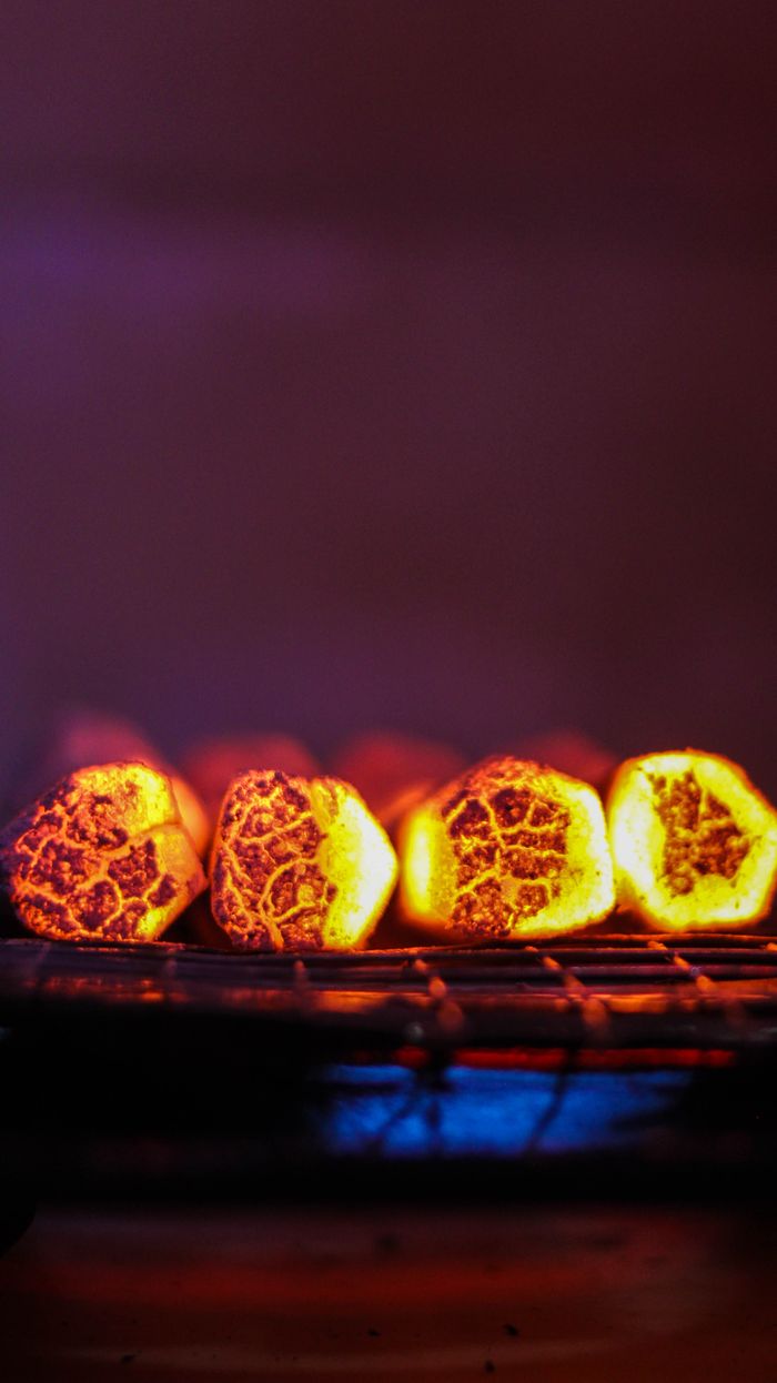 Crafting Captivating Headlines: Your awesome post title goes here Close-up of glowing charcoal briquettes on a grill, ready for outdoor cooking.